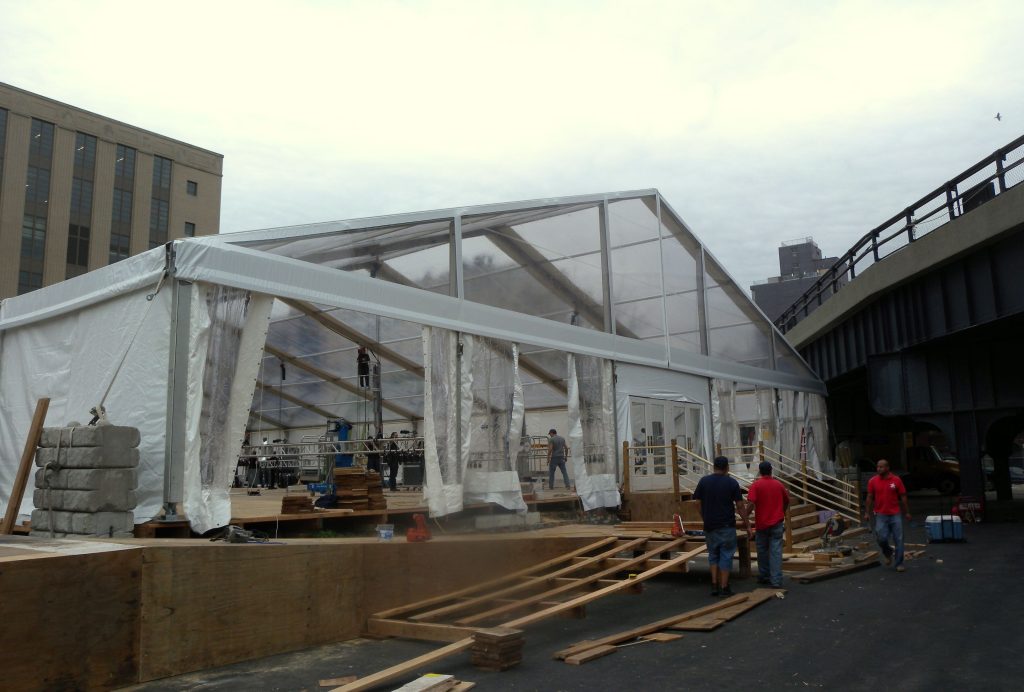 Large event tent being assembled for a Jose Mier party in Sun Valley