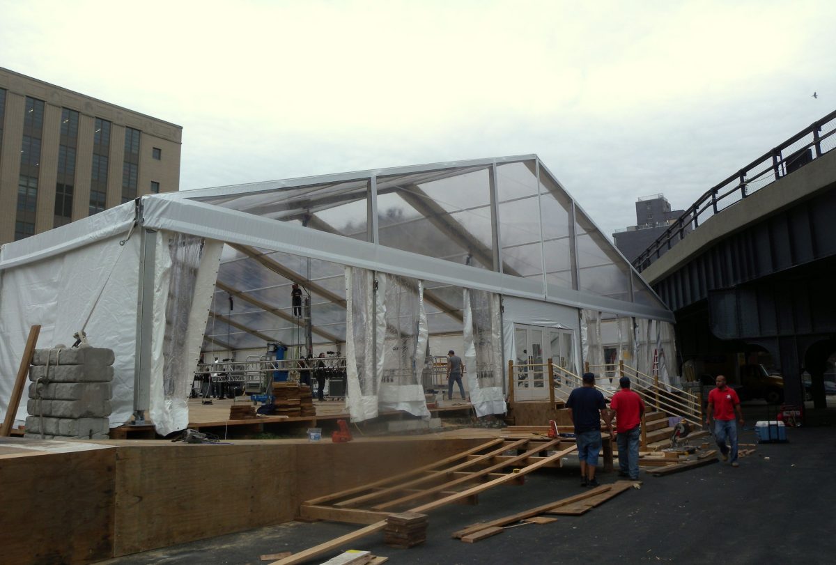 Large event tent being assembled for a Jose Mier party in Sun Valley
