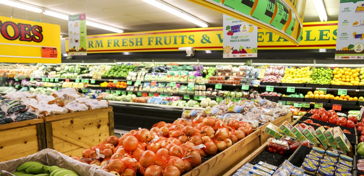 Fresh fruits and vegetables displayed in a grocery store produce section