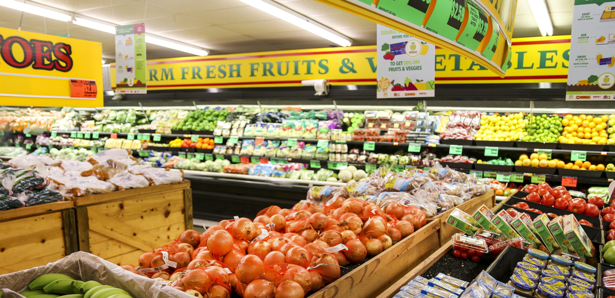 Fresh fruits and vegetables displayed in a grocery store produce section