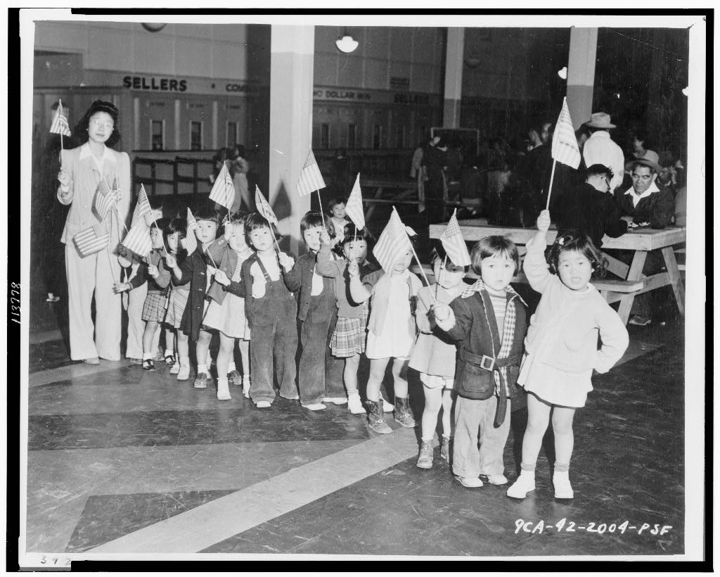 Japanese American children participating in a program at the Santa Anita Assembly Center in 1942, a historical image illustrating Japanese American community life in Southern California.