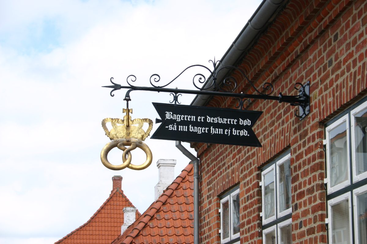Decorative shop sign illustrating the history and visual importance of business signage in the signage industry